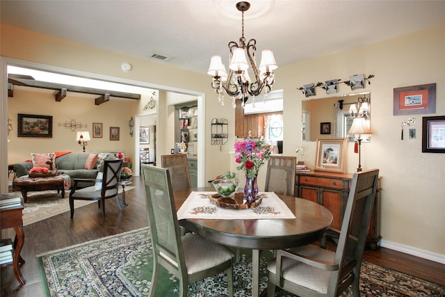 dining area with visible vents, baseboards, an inviting chandelier, and dark wood finished floors