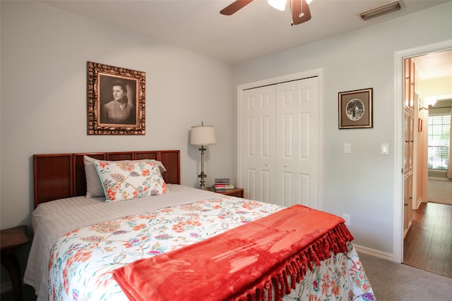 carpeted bedroom featuring a closet, visible vents, ceiling fan, and baseboards