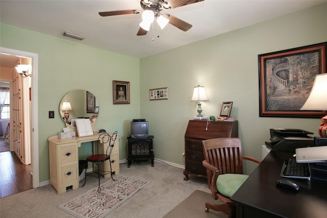 office featuring visible vents, baseboards, a ceiling fan, and carpet flooring