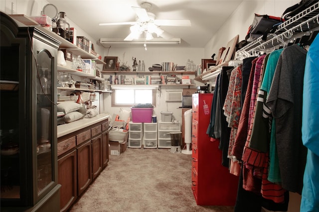 spacious closet with light carpet and ceiling fan