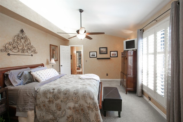 bedroom featuring vaulted ceiling, multiple windows, baseboards, and light carpet