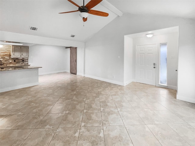 unfurnished living room with lofted ceiling with beams, a ceiling fan, visible vents, and baseboards