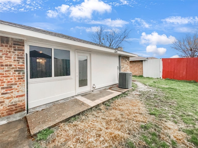 view of yard featuring central air condition unit and fence