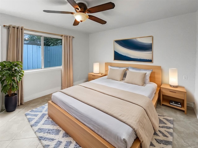 bedroom featuring tile patterned floors, baseboards, and a ceiling fan