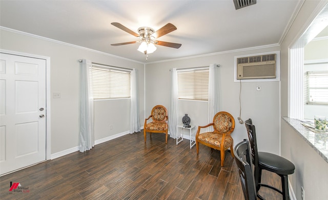 sitting room with visible vents, dark wood-type flooring, ornamental molding, and a wall mounted AC