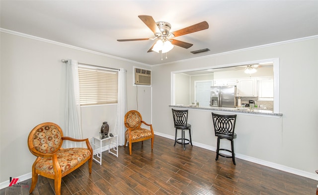 sitting room with a ceiling fan, dark wood-style floors, a wall mounted air conditioner, and ornamental molding