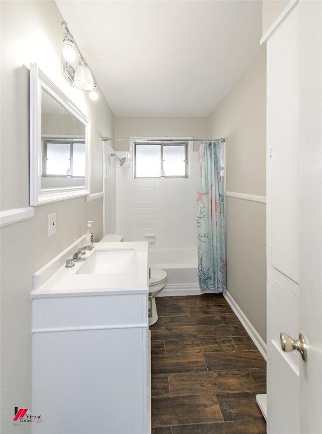 bathroom featuring baseboards, toilet, shower / tub combo with curtain, wood finished floors, and vanity