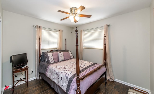 bedroom featuring baseboards, a ceiling fan, and dark wood-style flooring