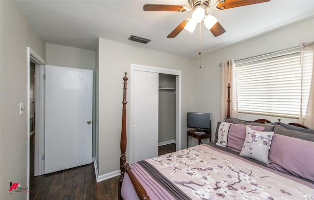 bedroom with a ceiling fan, visible vents, baseboards, dark wood finished floors, and a closet