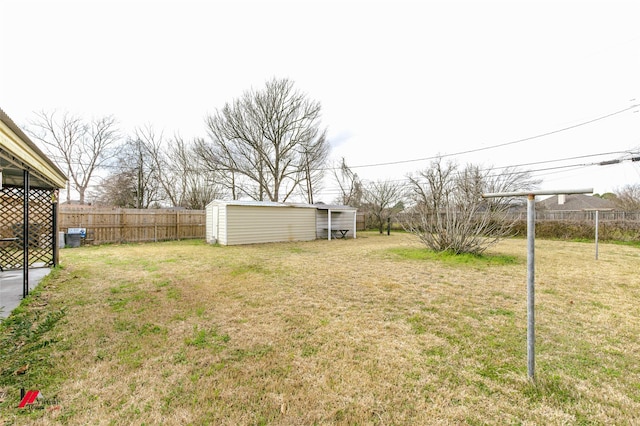 view of yard featuring an outdoor structure and fence