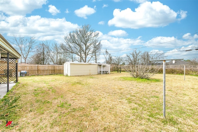 view of yard featuring an outbuilding and fence