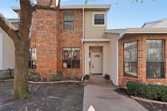 view of front of house with brick siding and stucco siding