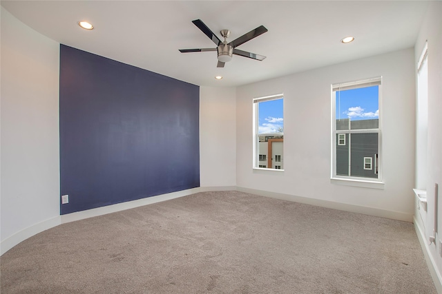 spare room with baseboards, recessed lighting, a ceiling fan, and carpet