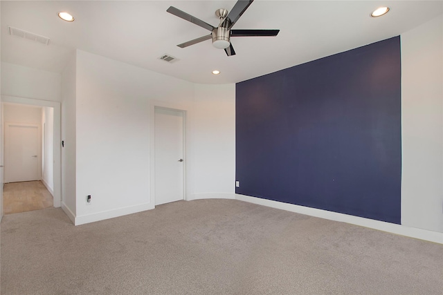 unfurnished room featuring recessed lighting, visible vents, and light carpet