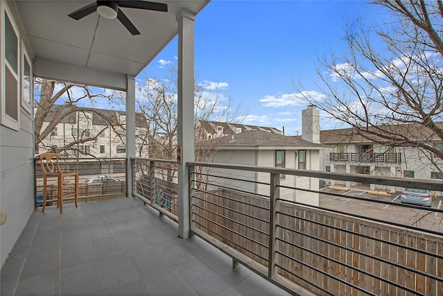 balcony with a residential view and ceiling fan