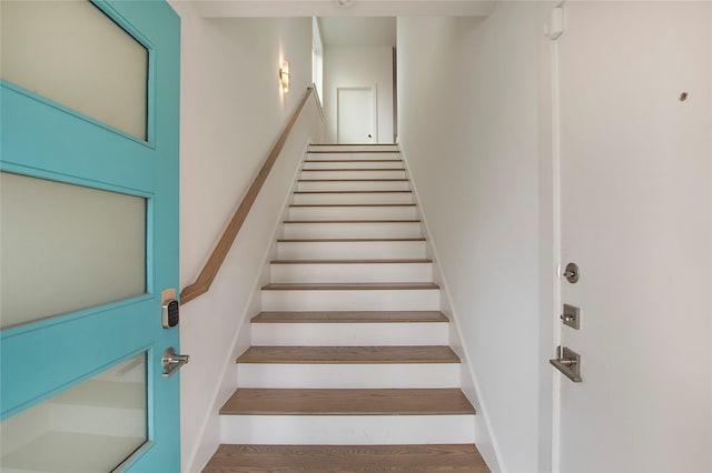 stairway with wood finished floors