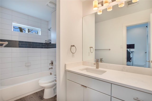 full bathroom with vanity, wood finished floors, visible vents, shower / bath combination, and toilet