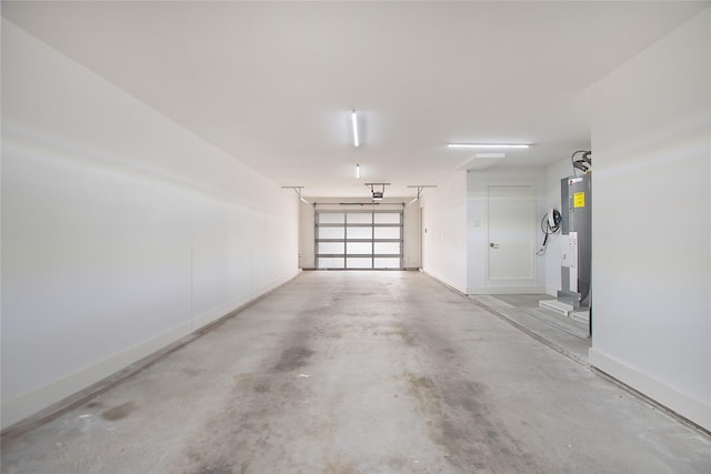 garage featuring baseboards, a garage door opener, and water heater