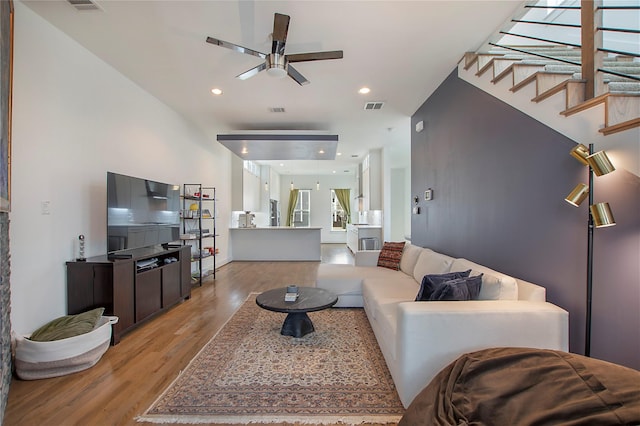 living room featuring visible vents, stairway, recessed lighting, light wood-style floors, and a ceiling fan