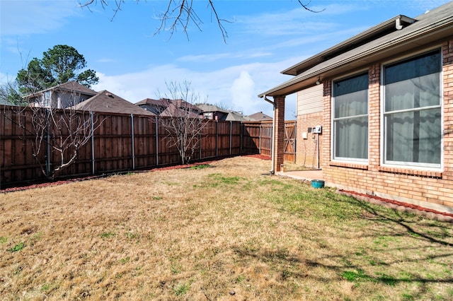 view of yard with a fenced backyard