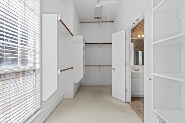 spacious closet featuring visible vents and a sink