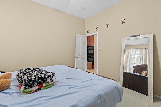 bedroom featuring light carpet