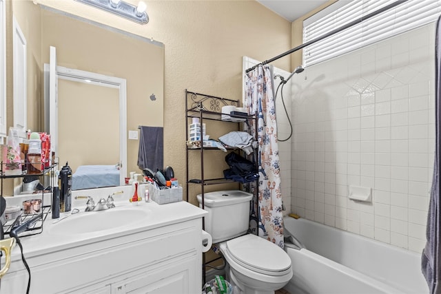 bathroom with toilet, shower / bath combo, vanity, and a textured wall