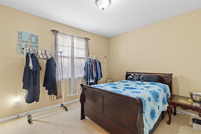 carpeted bedroom with baseboards