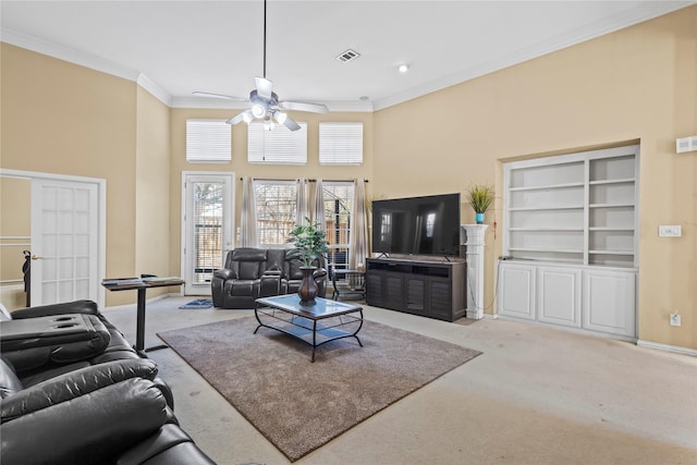 carpeted living area with baseboards, crown molding, ceiling fan, and a towering ceiling