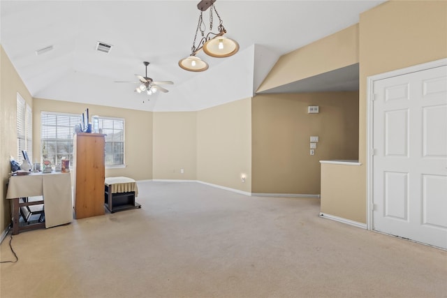 interior space featuring baseboards, light carpet, a ceiling fan, and vaulted ceiling