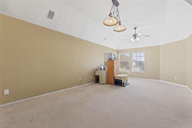 unfurnished room with baseboards, light colored carpet, ceiling fan, and vaulted ceiling