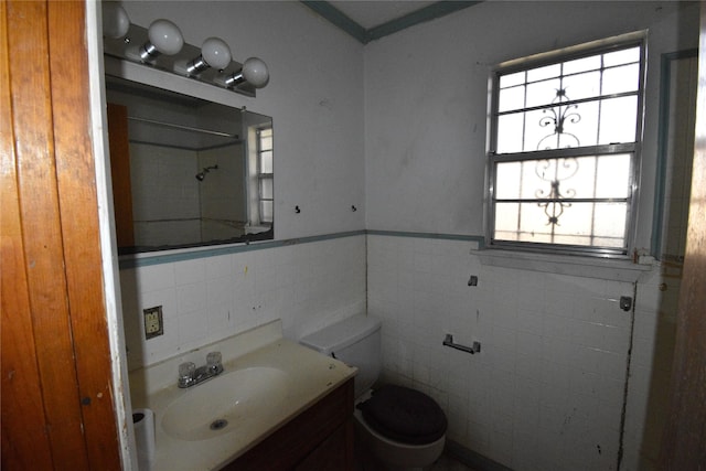 bathroom featuring a shower, toilet, and vanity