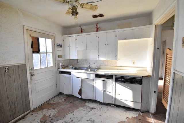 kitchen with visible vents, a wainscoted wall, white cabinets, light countertops, and dishwasher