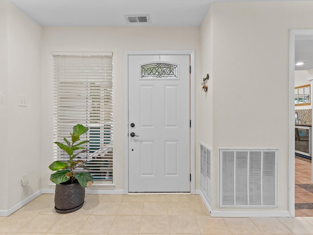 foyer featuring tile patterned floors, visible vents, wine cooler, and baseboards