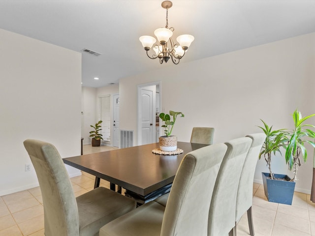 dining area with light tile patterned floors, visible vents, baseboards, and a notable chandelier