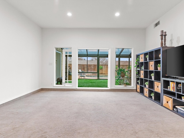 unfurnished living room featuring recessed lighting, visible vents, baseboards, and carpet flooring