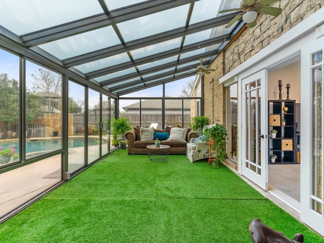 unfurnished sunroom with a wealth of natural light and ceiling fan