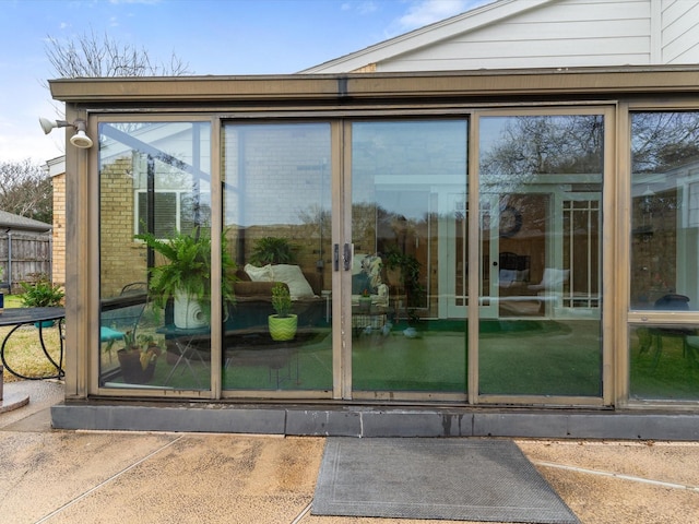 entrance to property featuring brick siding