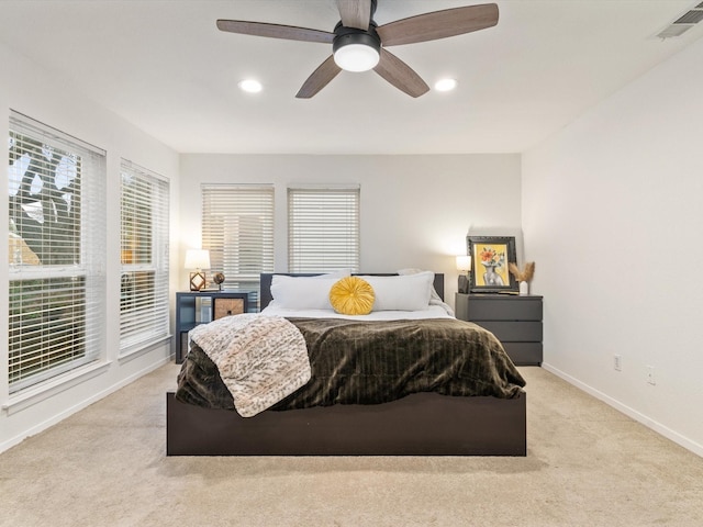 bedroom featuring visible vents, recessed lighting, baseboards, light colored carpet, and ceiling fan