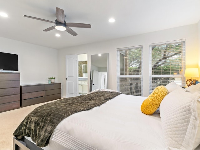 bedroom featuring recessed lighting, ensuite bath, and a ceiling fan