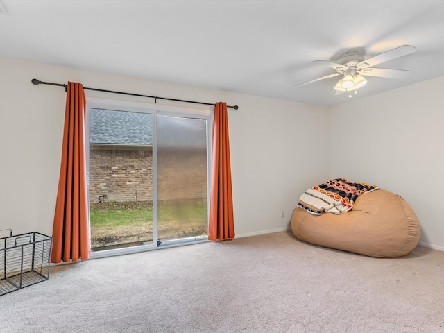 interior space featuring baseboards, a ceiling fan, and carpet flooring