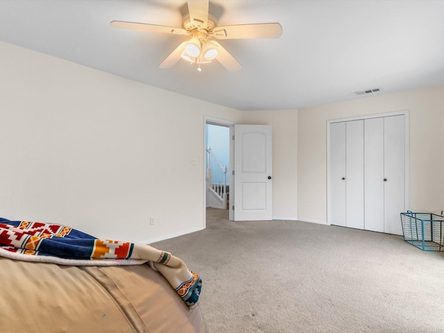 bedroom with visible vents, baseboards, carpet, and ceiling fan