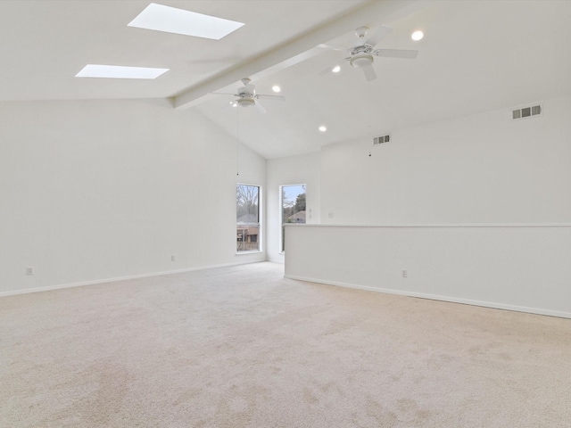 carpeted spare room featuring visible vents, baseboards, ceiling fan, and vaulted ceiling with beams