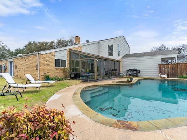 view of swimming pool featuring a patio, a fenced in pool, fence, and a sunroom