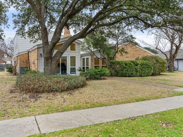 3320 Canyon Valley Trl, Plano, TX 75023 - view of front of house with brick siding, a chimney, and a front lawn