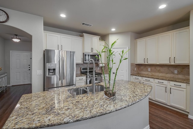 kitchen featuring white cabinets, visible vents, and stainless steel appliances