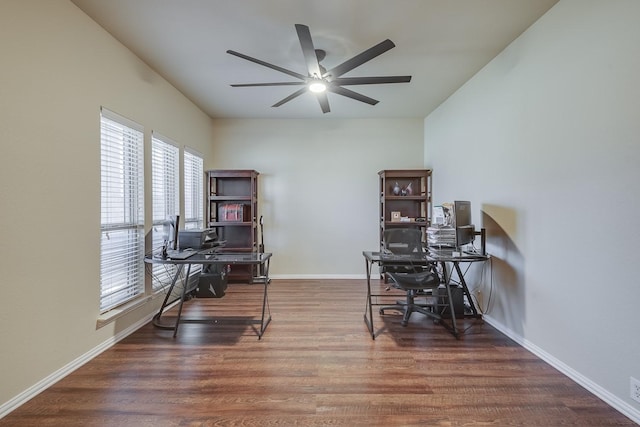 office space featuring ceiling fan, baseboards, and wood finished floors