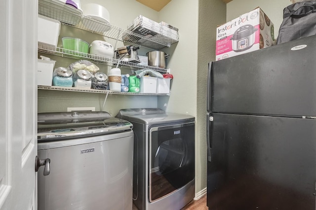 clothes washing area with laundry area and independent washer and dryer