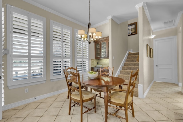 dining room featuring light tile patterned floors, stairway, plenty of natural light, and ornamental molding