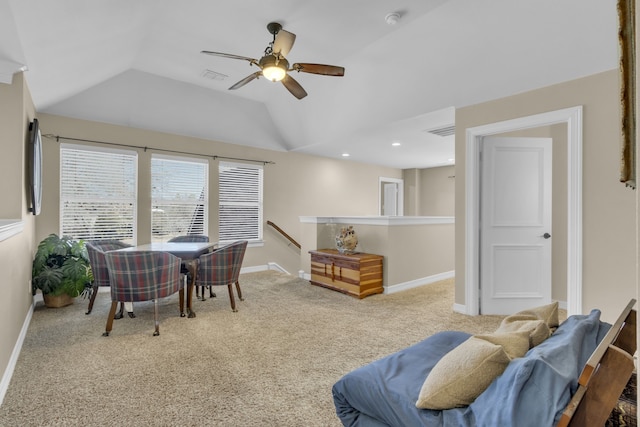 sitting room with visible vents, carpet flooring, baseboards, and vaulted ceiling